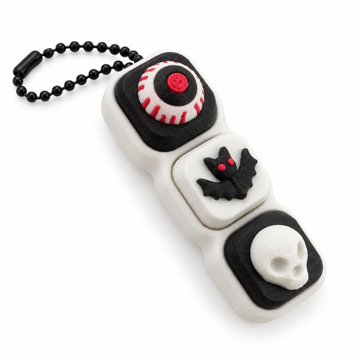 White and black Halloween clicker with eyeball bat and skull